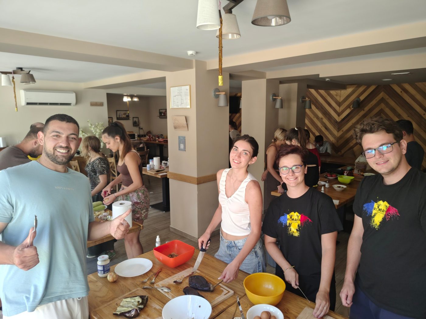 The Romanian team peels roasted eggplant for an eggplant salad