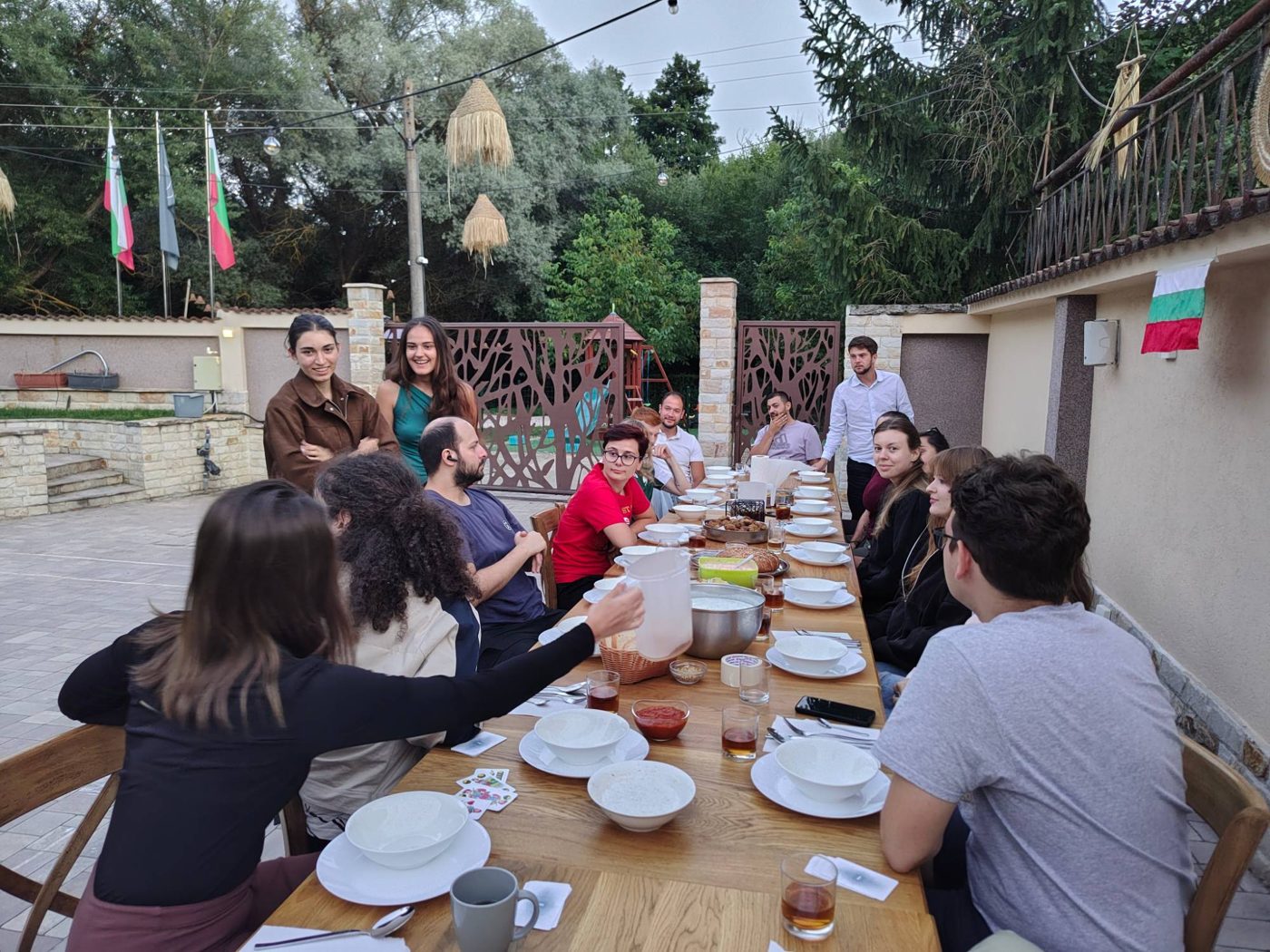 The table set for the Bulgarian evening, with Bulgarian flags in the garden