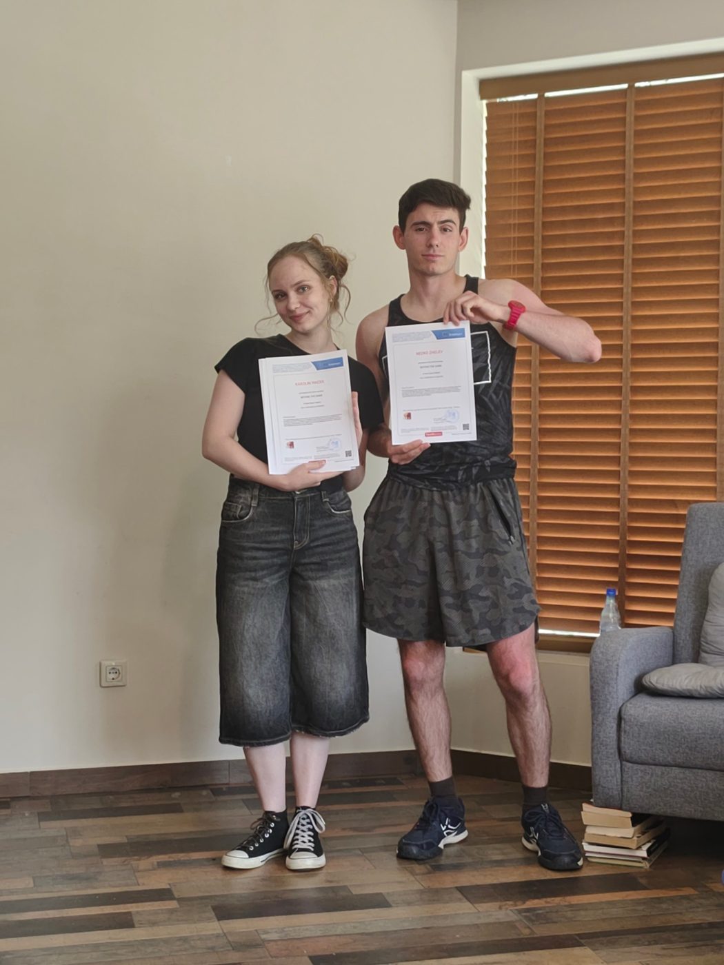Two participants proudly holding their Youthpass certificates