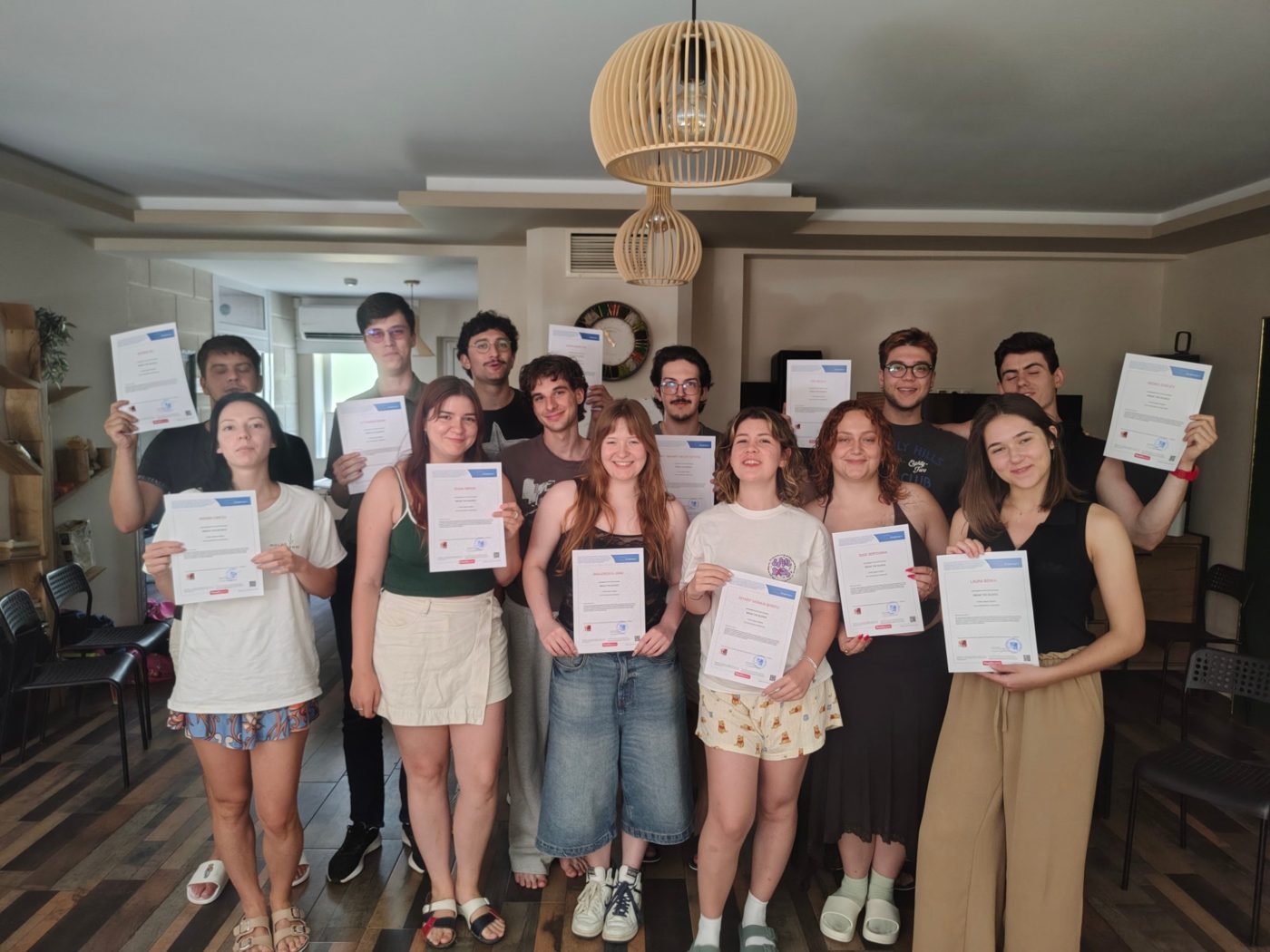 The whole group holding their Youthpass certificates at the end of the exchange