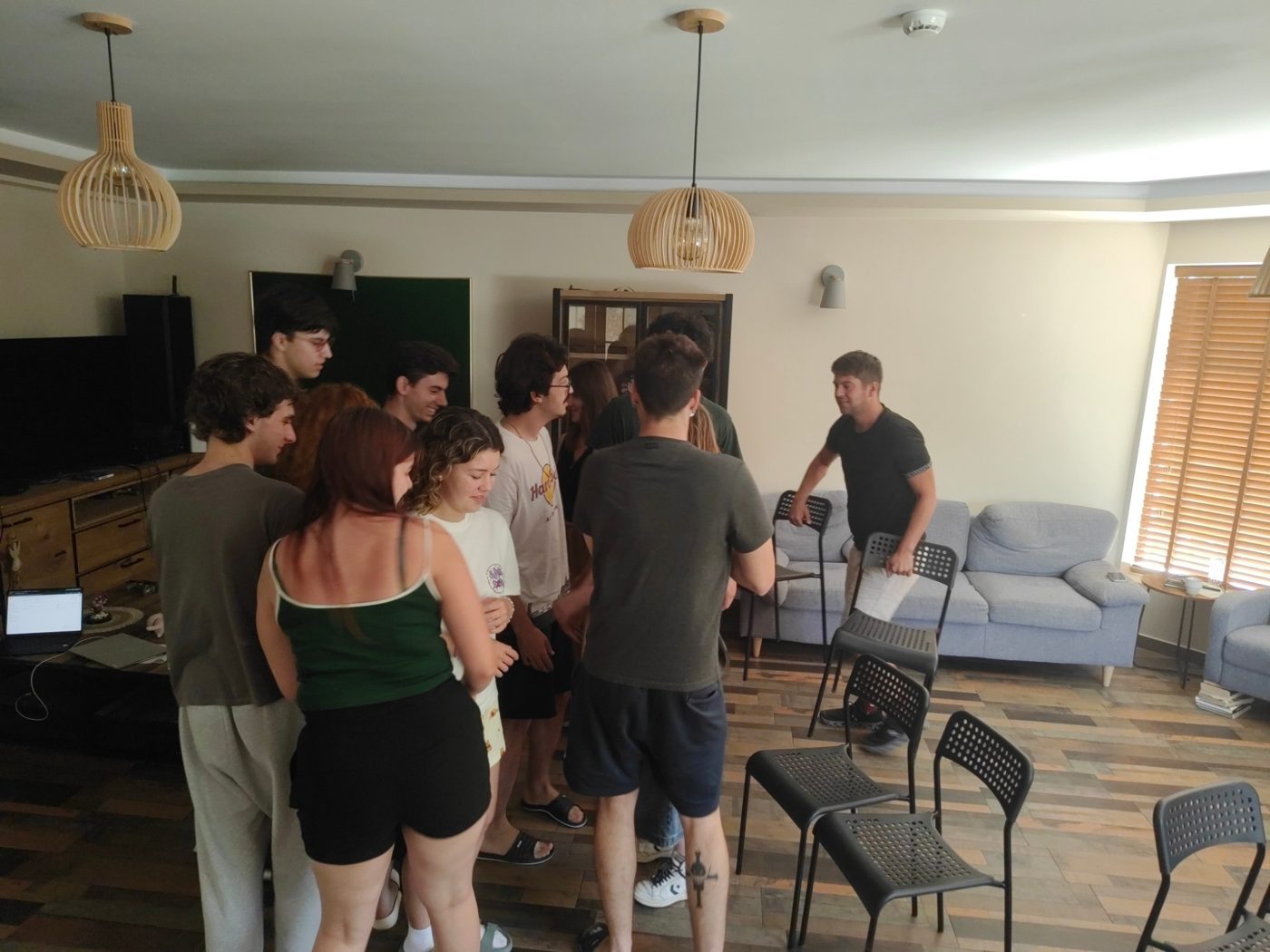 The group gathers close together for an exercise led by a facilitator