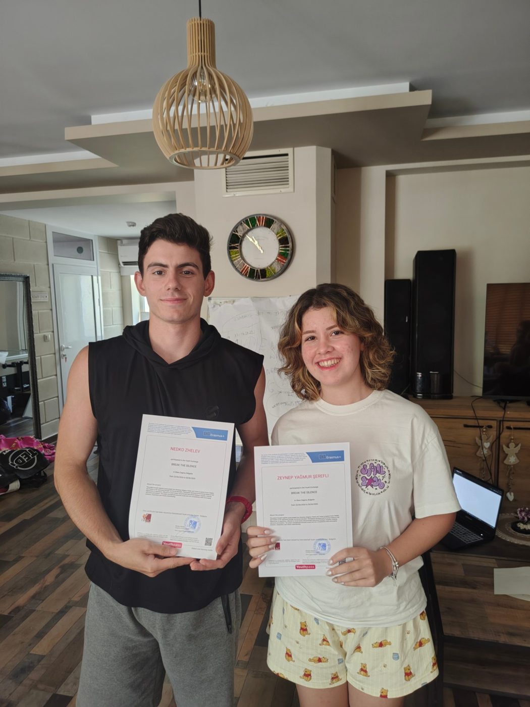 Two participants smiling with their Youthpass certificates