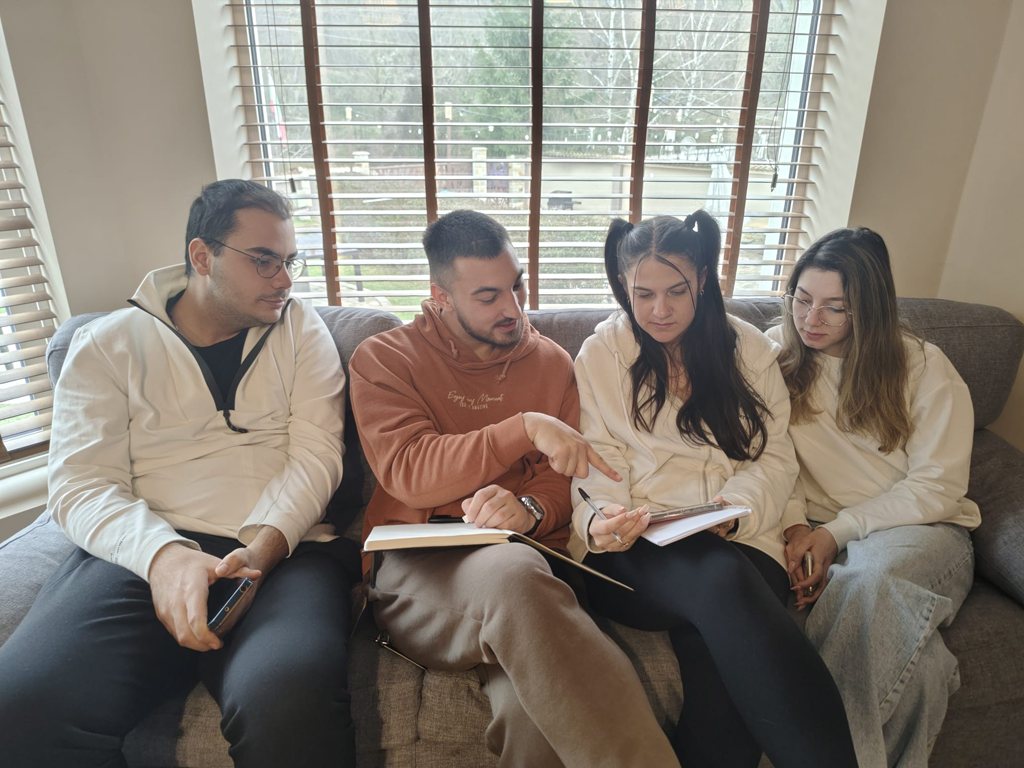 Participants reading together on a sofa