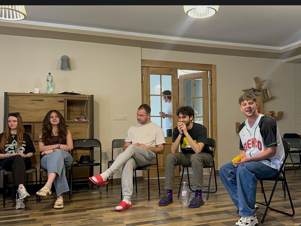 The group seated in a circle during a session