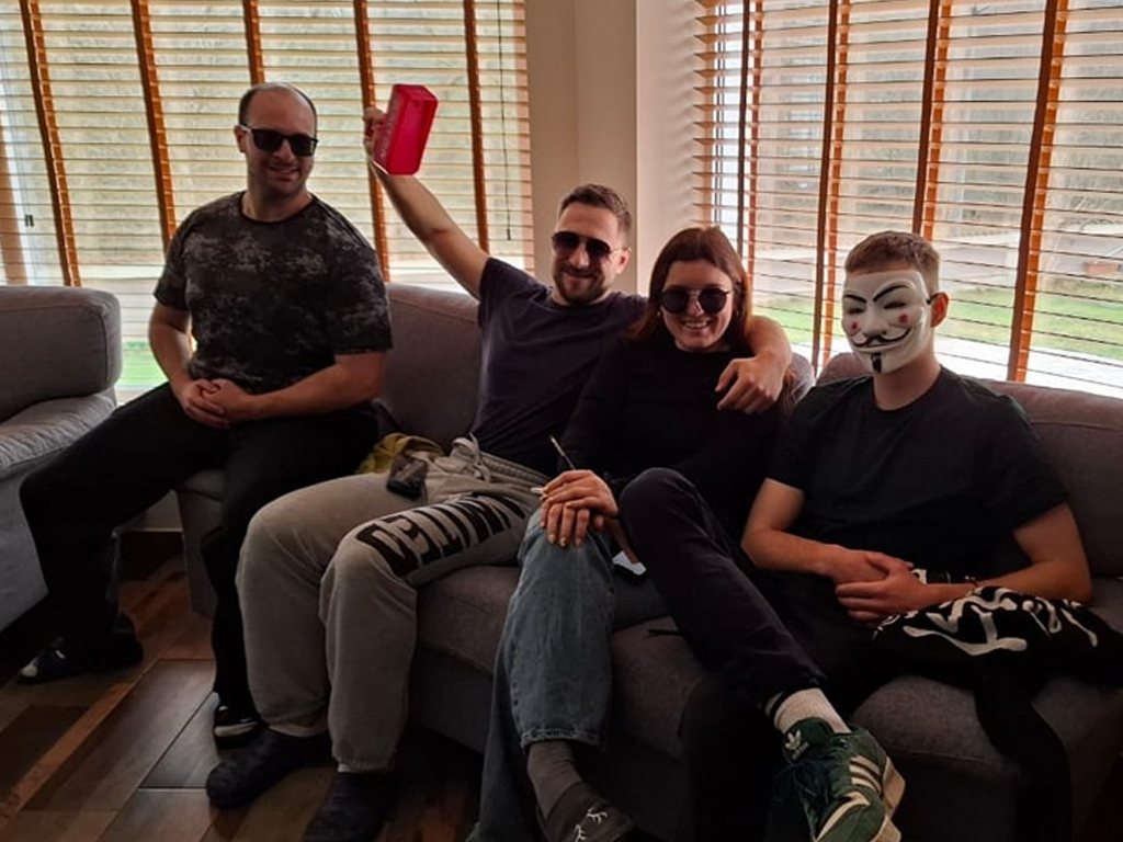 Participants in masks and sunglasses during an improvisation exercise