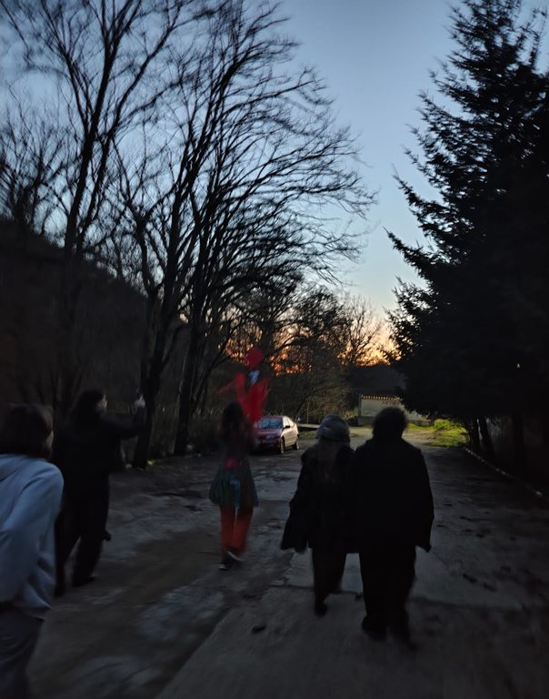 Participants walking outdoors at dusk