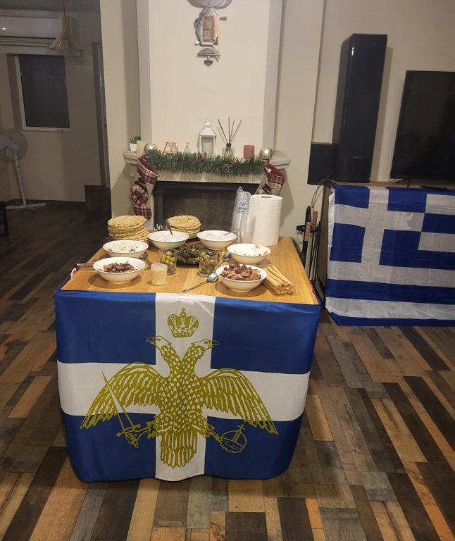 A Greek cultural evening table with flags and food