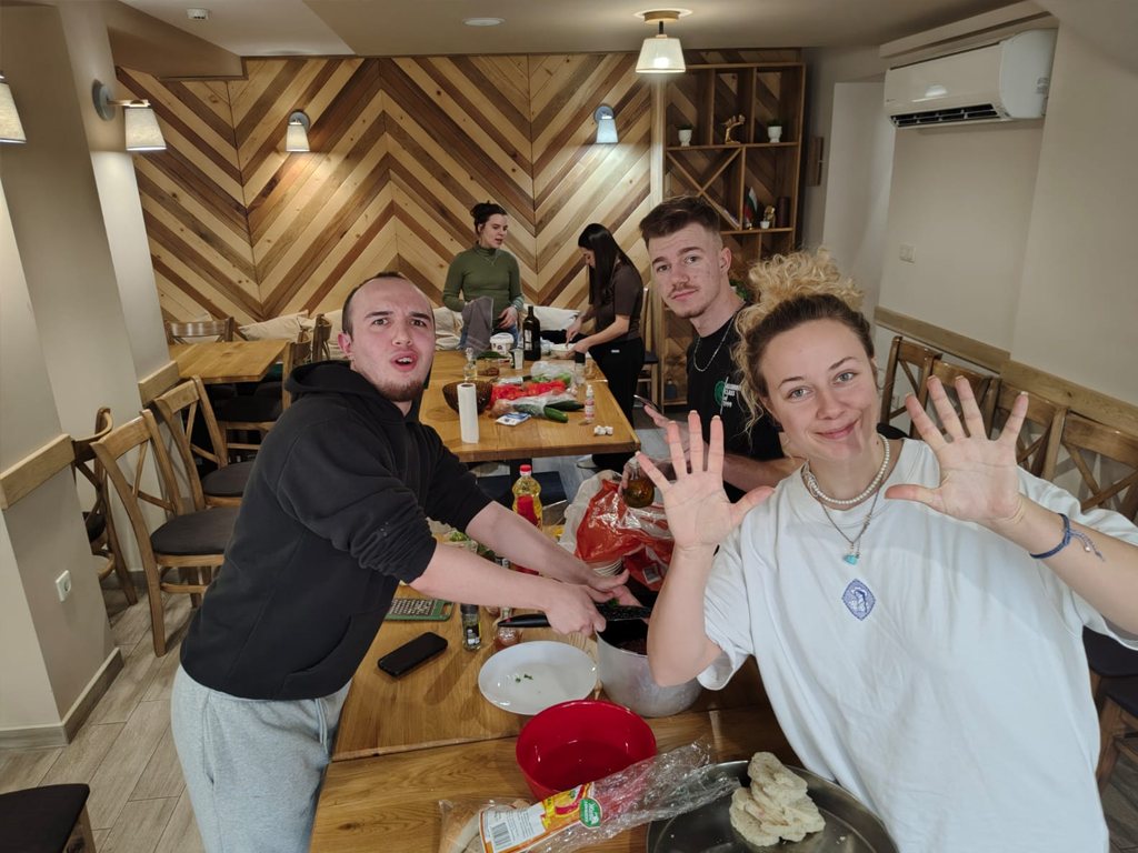 Participants waving during a cooking workshop