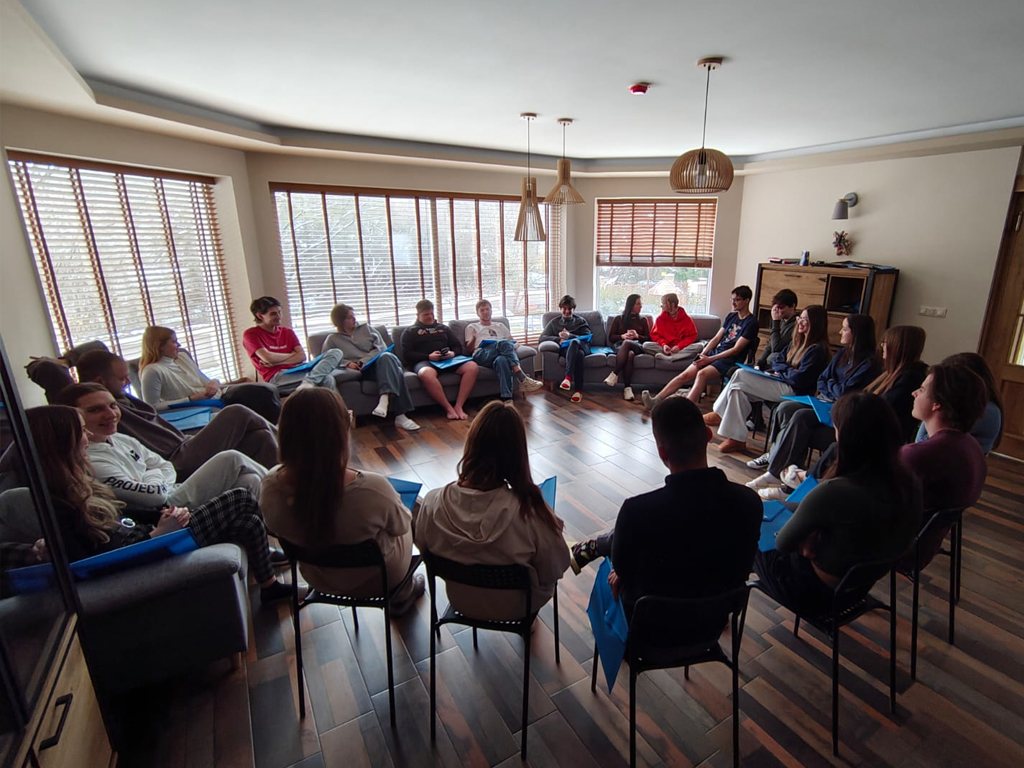 Participants seated in a large circle