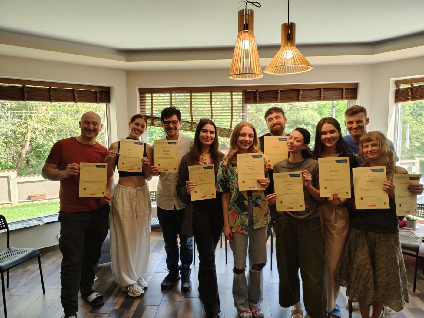 The participants holding their Youthpass certificates at the end of the training course