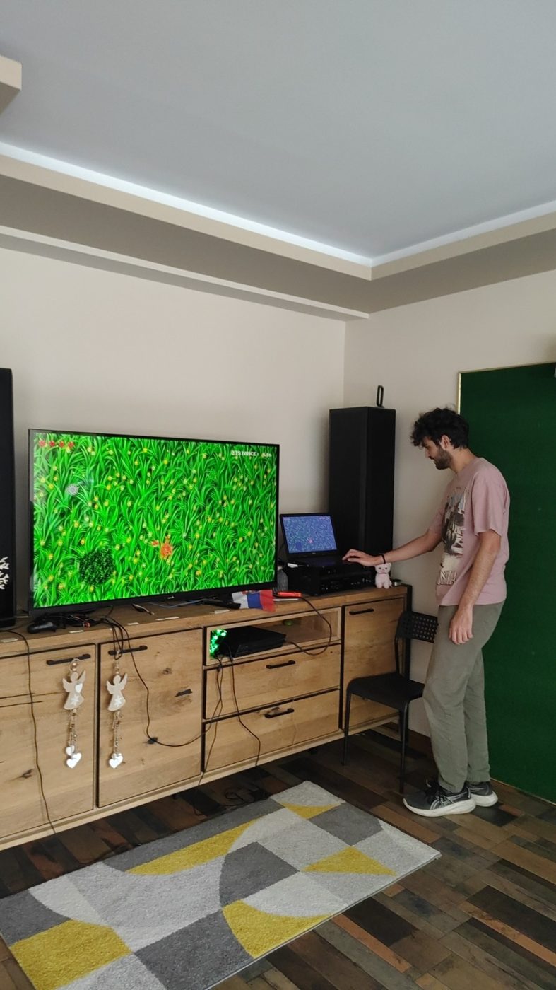 A participant shows a game on the big screen