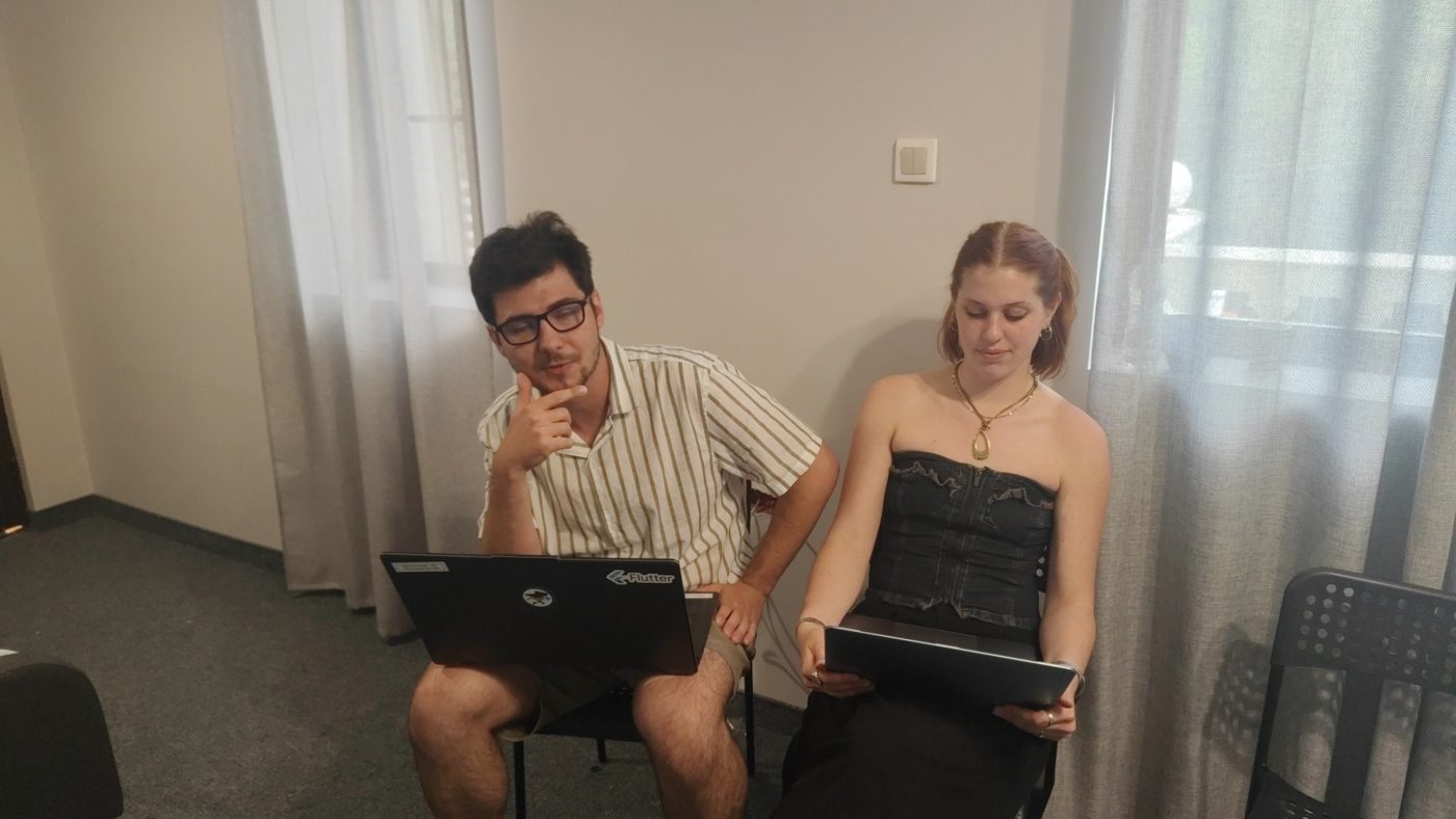 A pair of participants reviews their project plan on their laptops