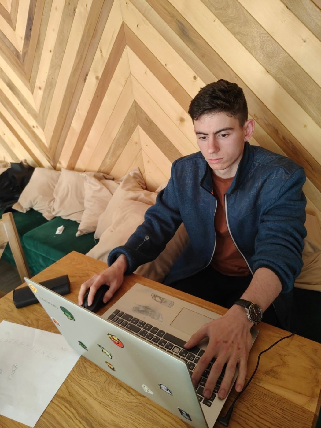 A participant writes a project application at a laptop